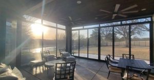Covered patio security screen enclosure with ceiling fans and security mesh walls in Plano TX by Security Screen Masters of Texas