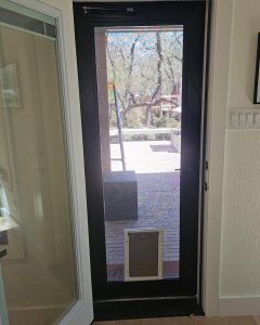 Custom bronze security screen door with built-in pet screen door in Austin TX by Security Screen Masters of Texas