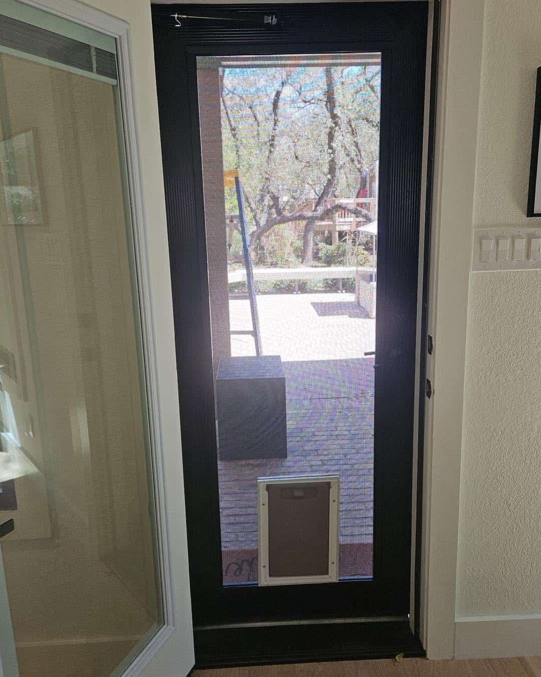 Custom bronze security screen door with built-in pet screen door in Austin TX by Security Screen Masters of Texas