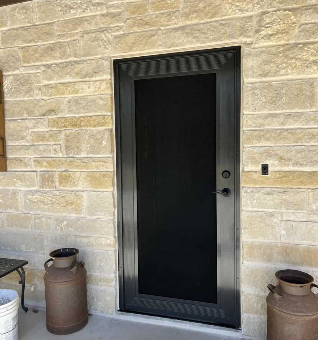 Bronze security screen door custom fit to stone entryway in San Antonio TX by Security Screen Masters of Texas