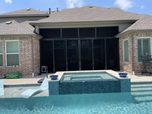 Poolside spa patio security enclosure with dark security screen panels in Dallas TX by Security Screen Masters of Texas