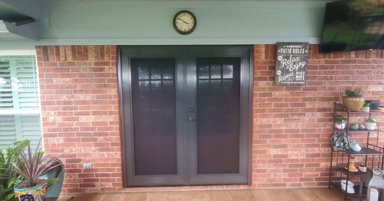 Bronze patio double French security screen doors installed on brick porch by Security Screen Masters of Texas
