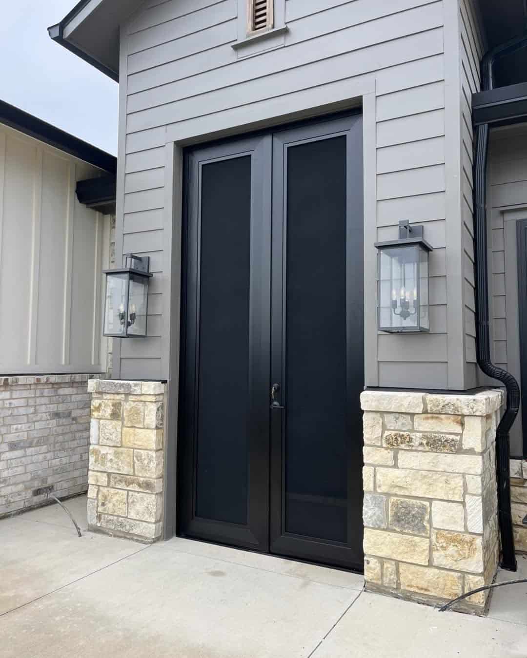 Tall black double French security screen doors on modern exterior by Security Screen Masters of Texas