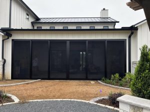 Modern farmhouse patio security enclosure with black security screens in Austin TX by Security Screen Masters of Texas