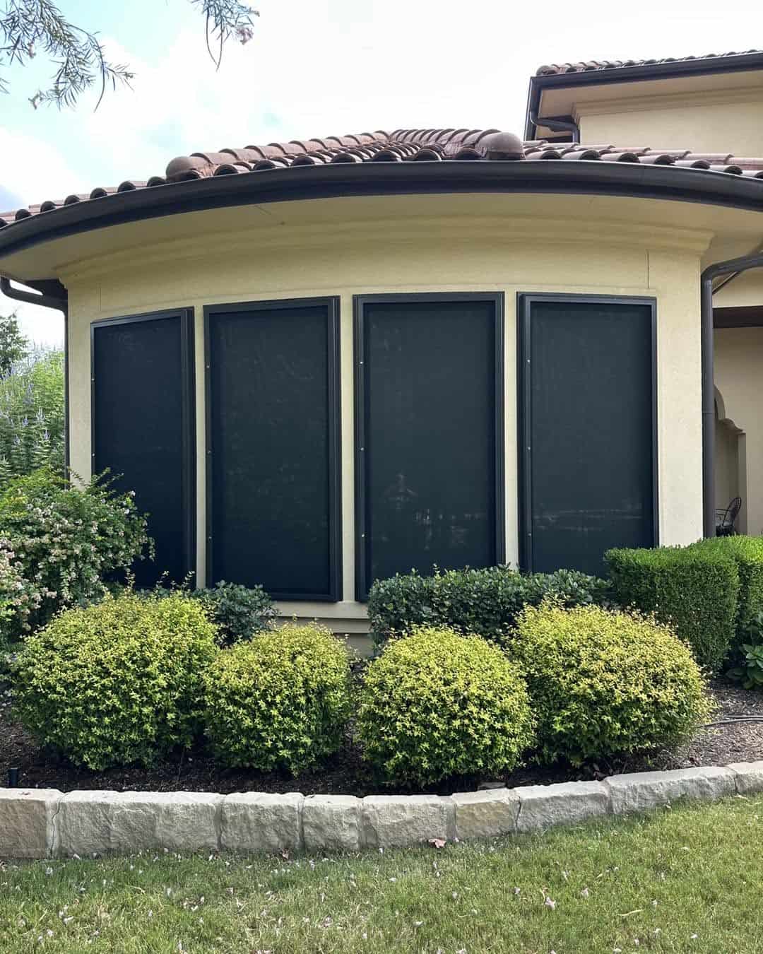 Four custom security window screens installed on curved bay window wall in San Antonio TX by Security Screen Masters of Texas