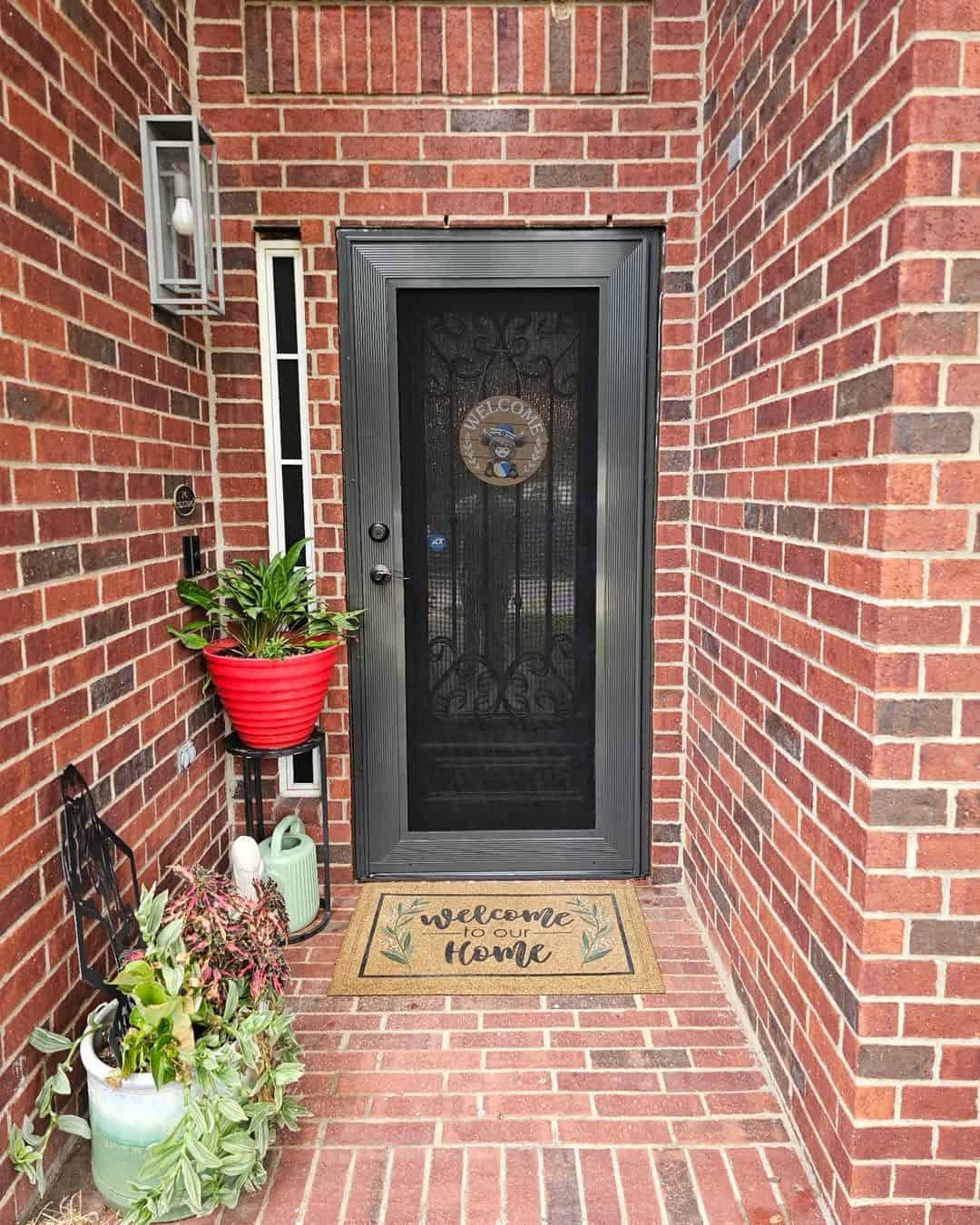 Decorative security screen entry door installed on red brick porch in DFW by Security Screen Masters of Texas