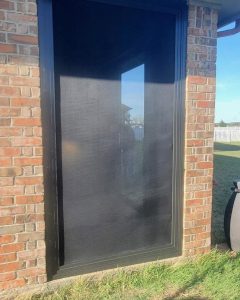 Single patio security screen door installed on brick exterior in North Texas by Security Screen Masters of Texas