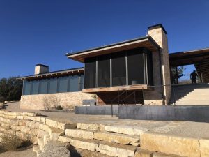 Luxury cantilevered screened patio enclosure on Texas limestone hillside in Austin TX by Security Screen Masters of Texas