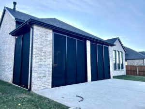 Multi-panel patio security screens installed on back patio in Plano TX by Security Screen Masters of Texas