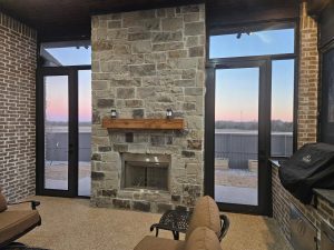 Interior view looking through security screens flanking fireplace at sunset by Security Screen Masters of Texas