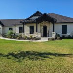 Full facade security window screens and entry door on Texas luxury ranch home by Security Screen Masters of Texas