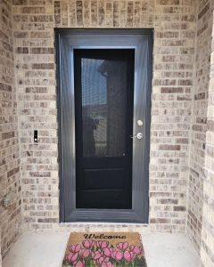 Front porch security screen door with floral welcome mat in Fort Worth TX by Security Screen Masters of Texas